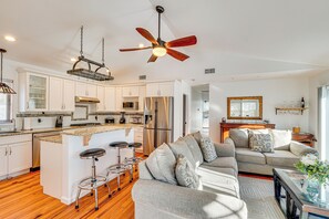 A modern kitchen with white cabinets, stainless steel appliances, and a central island with stools. - Hudson Valley Retreat w/ Pool Near Greenwood Lake (Monroe)