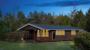 A single-story house with a sloped roof, a front porch, and a well-maintained lawn. - Relaxing holiday home near water and Jesperhus (Roslev)