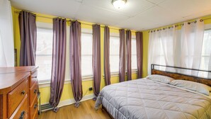 A bedroom with a bed, wooden dresser, and curtains. - 11 Mi to Dtwn Cleveland: Family Home w/ Yard (Garfield Heights)