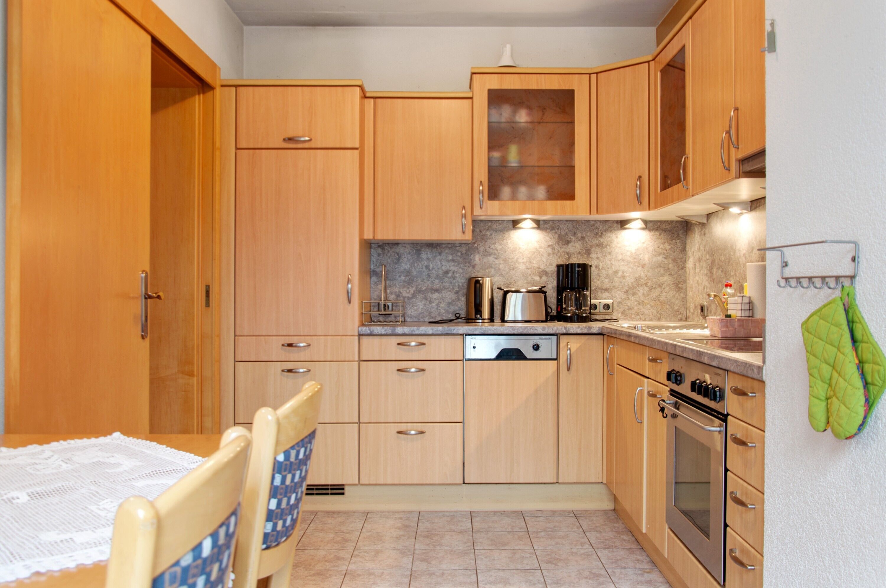 A kitchen with wooden cabinets, a dishwasher, a stove, and a microwave.