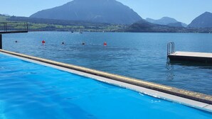 A swimming pool with a clear view of mountains in the background.