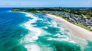 An aerial view of a coastal area with a sandy beach and a residential neighborhood. - Sun Soaked - Lennox Village Apartment (Lennox Head)