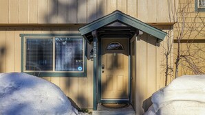 A house with a front door, a window, and a mailbox. - Trailside Tahoe Townhouse (Tahoe city)