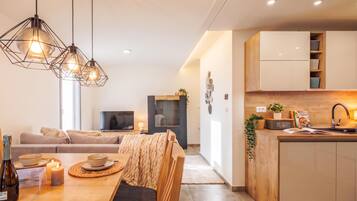 A modern kitchen with wooden cabinets, a built-in oven, and a sink.
