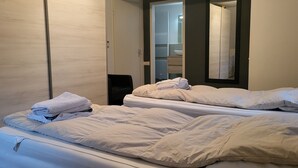 A hotel room with two beds, a large mirror, and a walk-in closet. - Lovely family home in Laren (Laren)