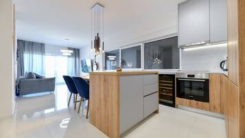Deluxe Apartment, Sea View | Private kitchen | Electric kettle, toaster, high chair
