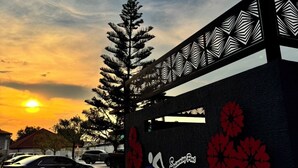 A building with a logo for 'Swimming Pool' and decorative red flowers on the wall.