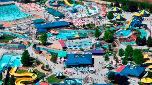 An aerial view of a water park with multiple pools, slides, and umbrellas. - Single Level, Luxury 4BR, Hot Tub, Game Room, Exercise Area, Near Discovery Park (Meridian)