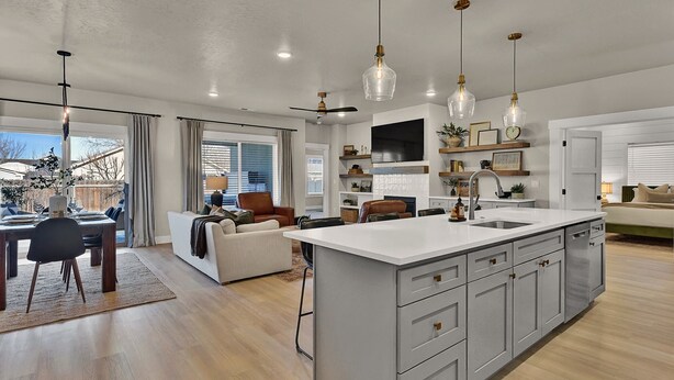 A spacious kitchen with a large island, pendant lighting, and a built-in TV. - Single Level, Luxury 4BR, Hot Tub, Game Room, Exercise Area, Near Discovery Park (Meridian)