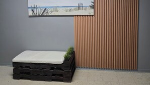 A room with a bed, a wall-mounted picture, and a number '6' sign. - Only by boat chic 2-bedroom apartment with AC, WiFi in private island in Fajardo (Fajardo)