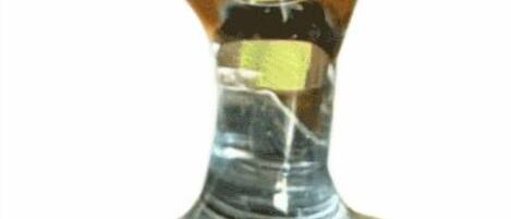 A clear glass with a yellow straw.