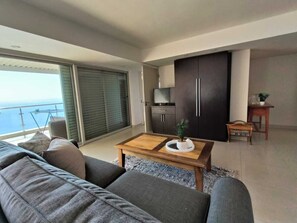 Deluxe Studio Suite, Ocean View | Living area | TV