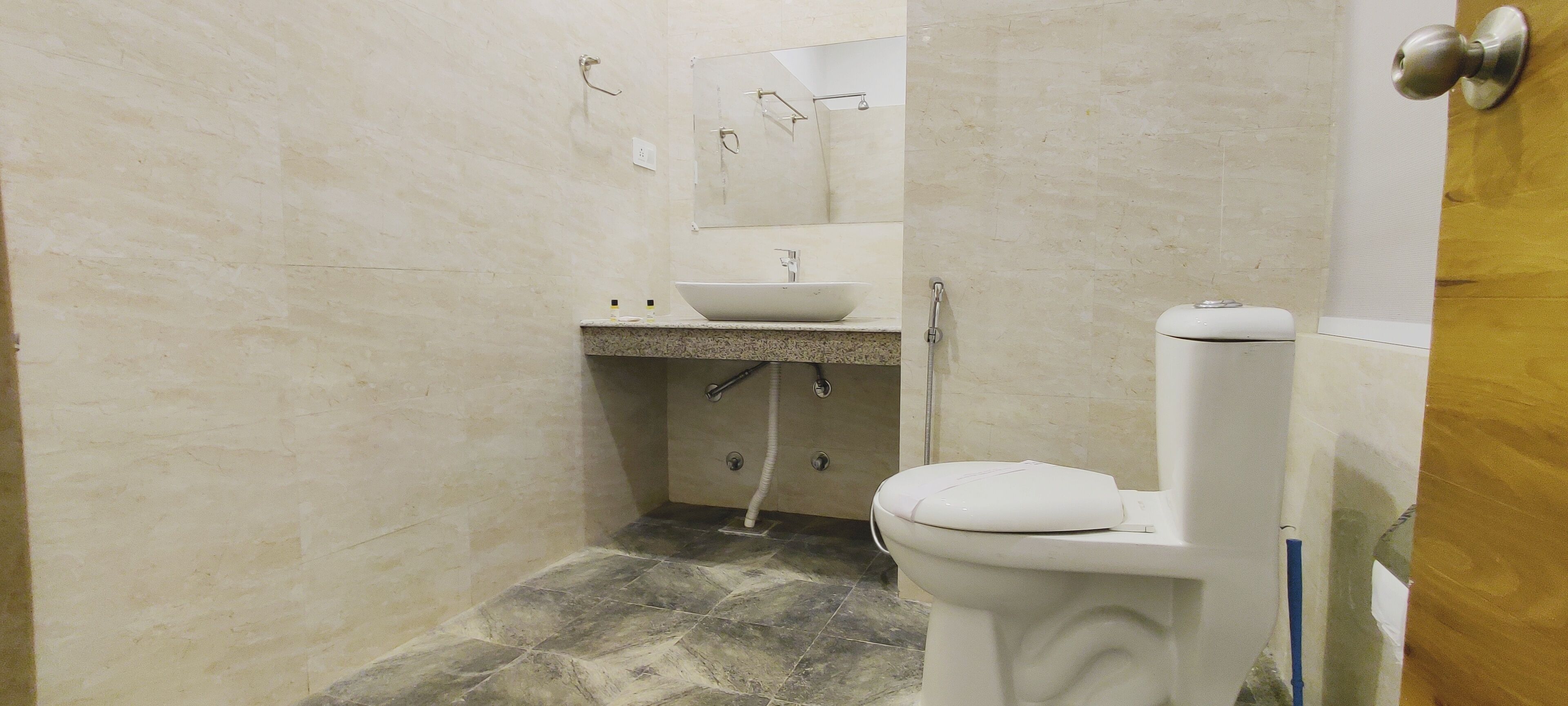 A bathroom with a white toilet, a sink, and a shower.