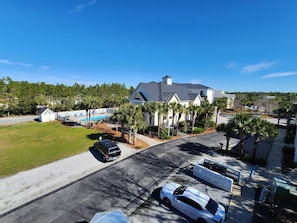 A residential area with a large house, a swimming pool, and a well-maintained lawn.