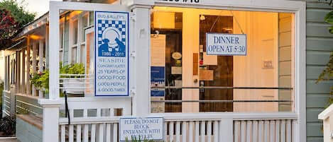 A restaurant named Bud & Alley’s with a sign indicating dinner opens at 5:30.