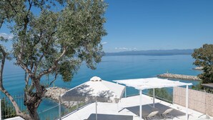 Eine Terrasse mit Sitzgelegenheit und Meerblick.