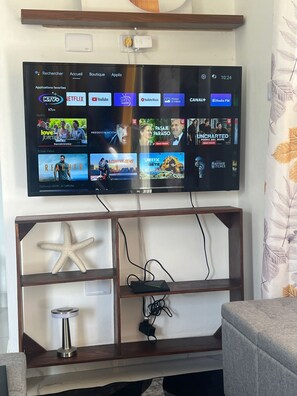 Relax in this stylish living room with a flat-screen TV and comfortable seating area.