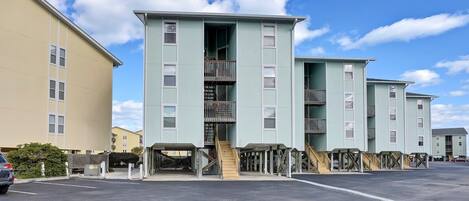 A multi-story building with a central staircase and balconies.