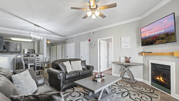 Deluxe Condo, 1 Bedroom, Mountain View | Living room | 55-inch TV with cable channels, fireplace