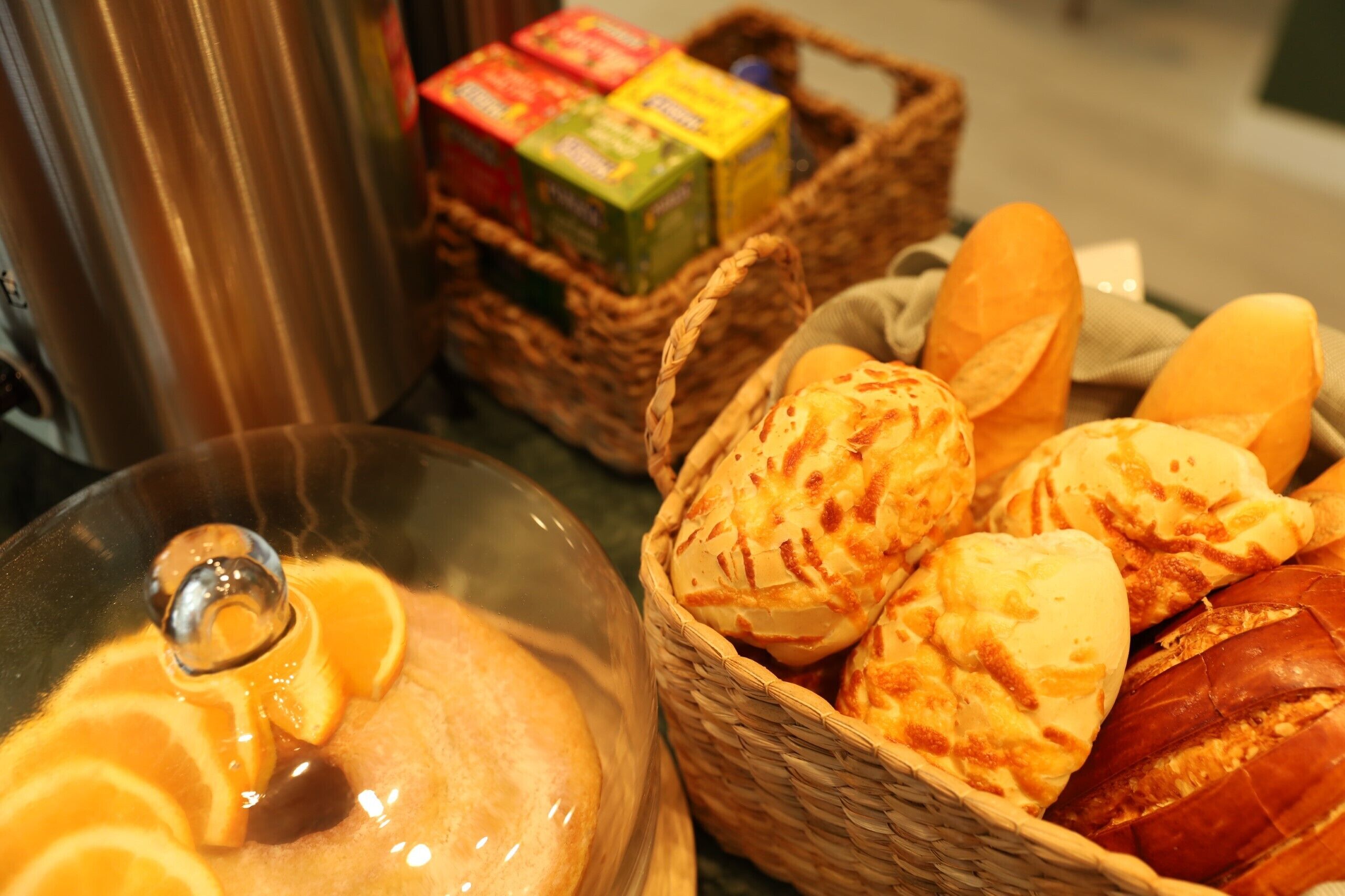 A basket of bread and a glass bowl with bread slices.
