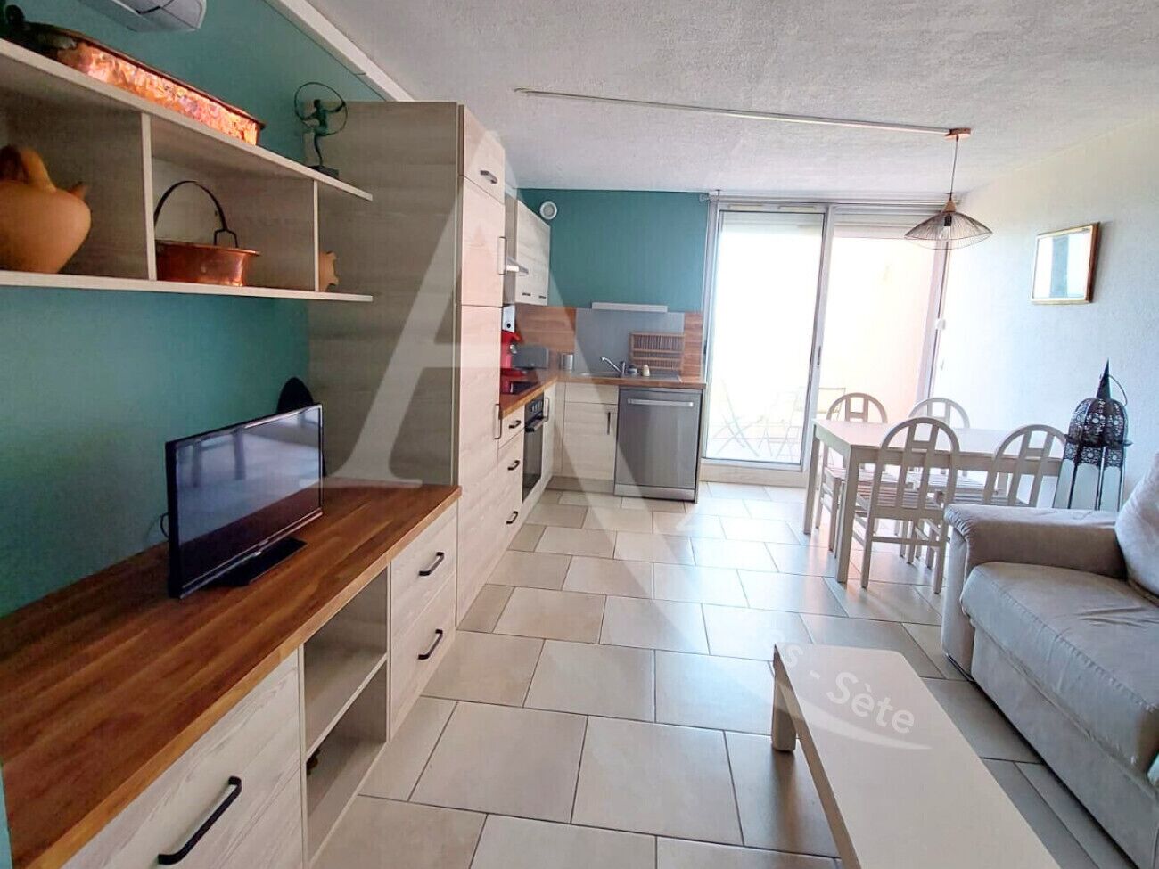 A compact living space with a kitchenette, a dining area, and a seating area.