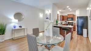 A modern kitchen with wooden cabinets, a refrigerator, and a microwave. - 3 Mi to Old Town: Albuquerque Townhome w/ Yard! (Albuquerque)