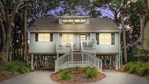 A two-story house with a balcony, a front porch, and a driveway.