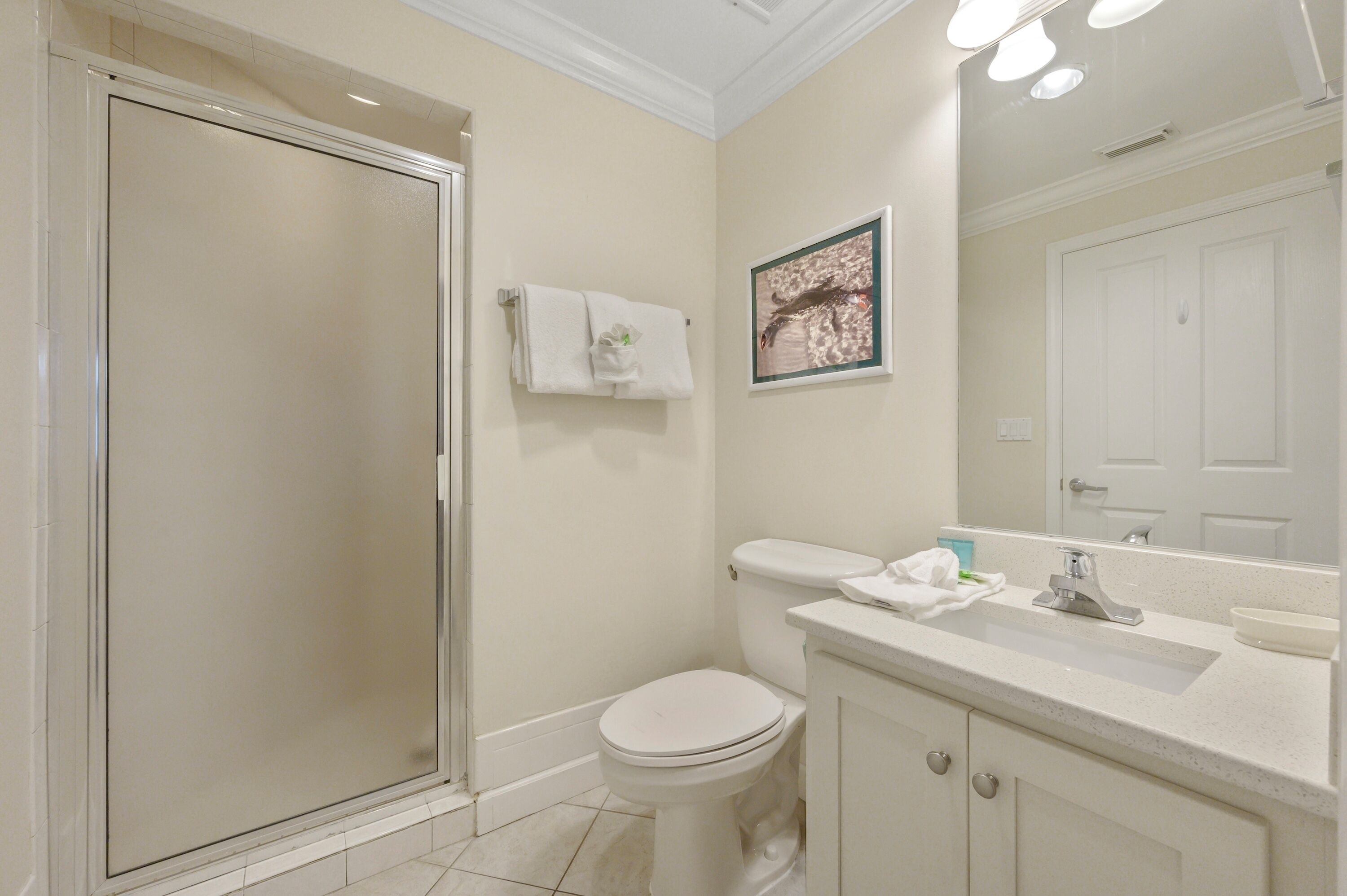 A bathroom with a toilet, sink, and shower.