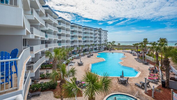 A hotel with a large pool, outdoor seating, and a view of the ocean. - G316 Gulf-view 2BR+ bunk room w/ balcony, pool access & free beach service (Fort Walton Beach)