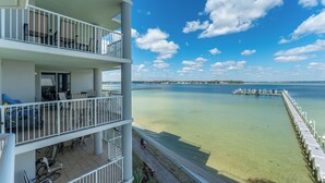 A multi-story hotel with balconies overlooking a clear beach and calm sea. - O401 Corner Condo w/ Expansive Bay Views | Huge Balcony | Pools & Lazy River! (Fort Walton Beach)