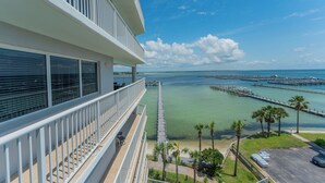 A hotel balcony with a view of the ocean and a pier. - O601 Oversized Bayside Luxury | Pool Table | Lazy River & Resort Pools (Ft. Walton Beach)
