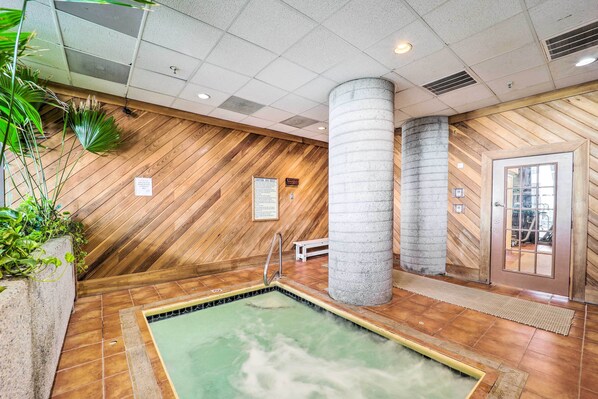 A traditional Japanese onsen with wooden walls, a stone pillar, and a small wooden bench. - Pool Access! Ski-in/out Sugar Mtn Gem w/ Views (Banner Elk)