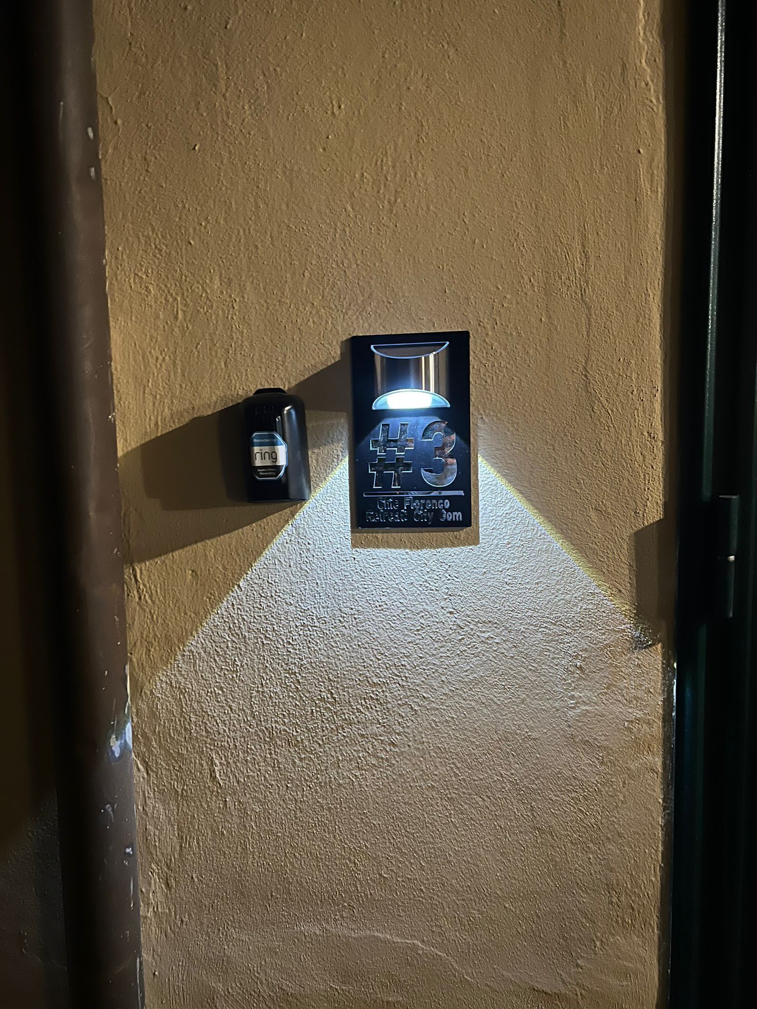 A wall-mounted sign with a #3 symbol, indicating a third-floor location.