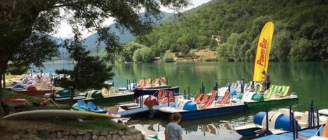 A lakeside dock with boats and a PowerBar flag.