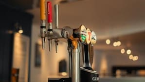 Un système de distribution avec plusieurs robinets à bière et une poignée de robinet portant l’inscription « GLU ».