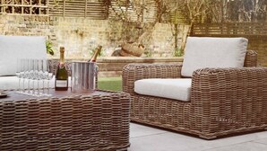 Wicker furniture with cushions, a bottle of champagne, and glasses on a patio. - Luxury 5-Bedroom, Central London Town House (Greater London)