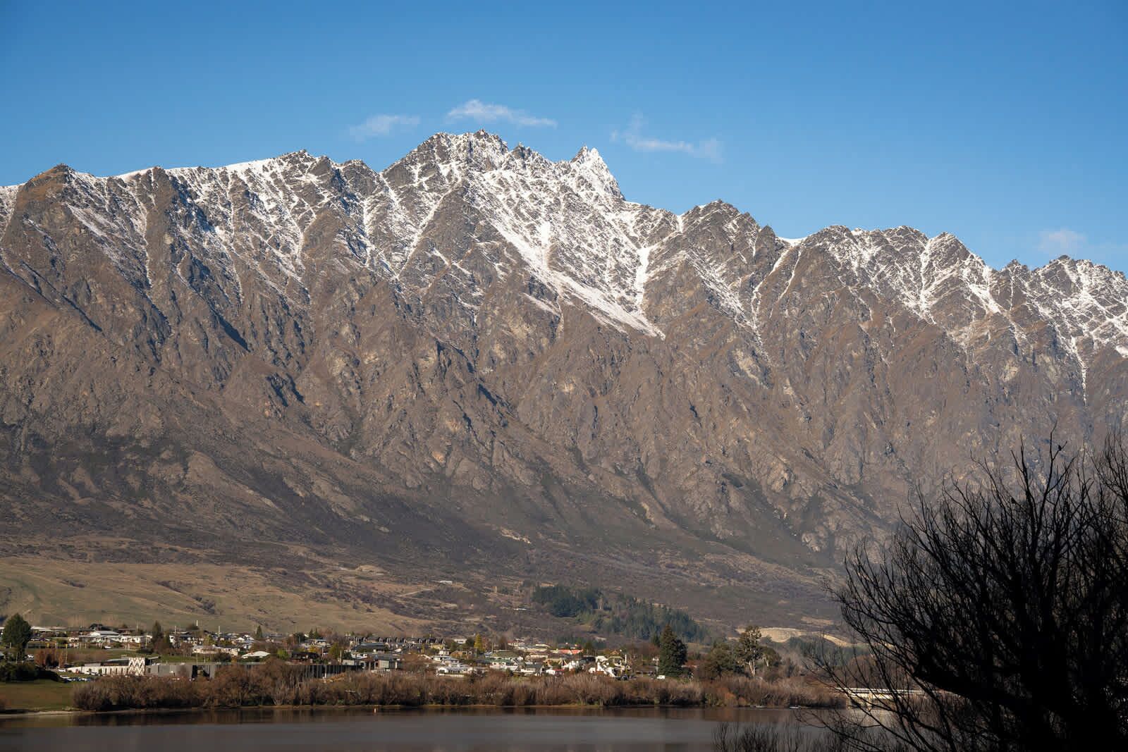 A mountainous landscape with a town in the foreground.