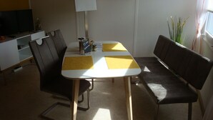 A dining area with a table, chairs, a lamp, and a television. - Vacation cottage in the countryside approx. 150m from the SpreewaldTherme-S (Burg (Spreewald))