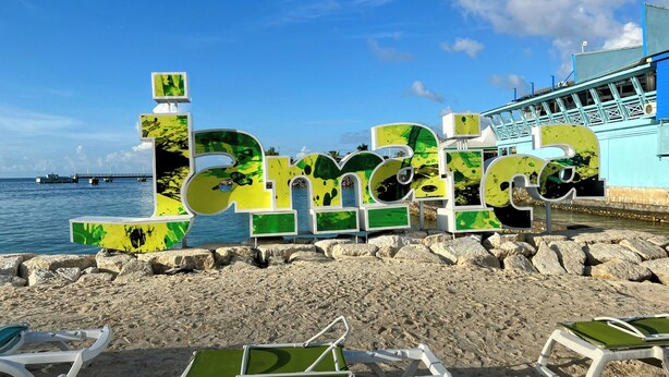 A beach with large green and yellow letters spelling "Bariloche" and a pier in the background. - Paradise on the Rocks - Suite w/Kitchenette #9 (Negril)