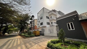 A residential building with a gated entrance, a water tank on the roof, and a well-maintained garden area. - SUNSET VIEW PENTHOUSE CONDO at UTAKO ABUJA. 24hrs LIT with AC, WIFI & KITCHEN (Abuja)