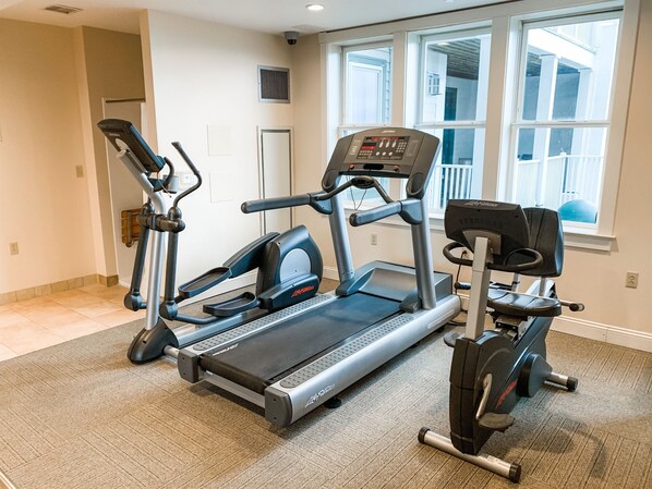 A home gym with a treadmill, elliptical, and stationary bike. - NEW! Seneca 113: Private Entrance, Hot Tub, Heated Garage, Sleeps 6! (Snowshoe)