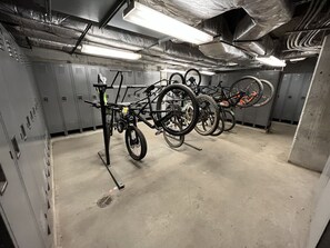 A bike storage area with multiple bicycles secured on racks. - NEW! Seneca 113: Private Entrance, Hot Tub, Heated Garage, Sleeps 6! (Snowshoe)