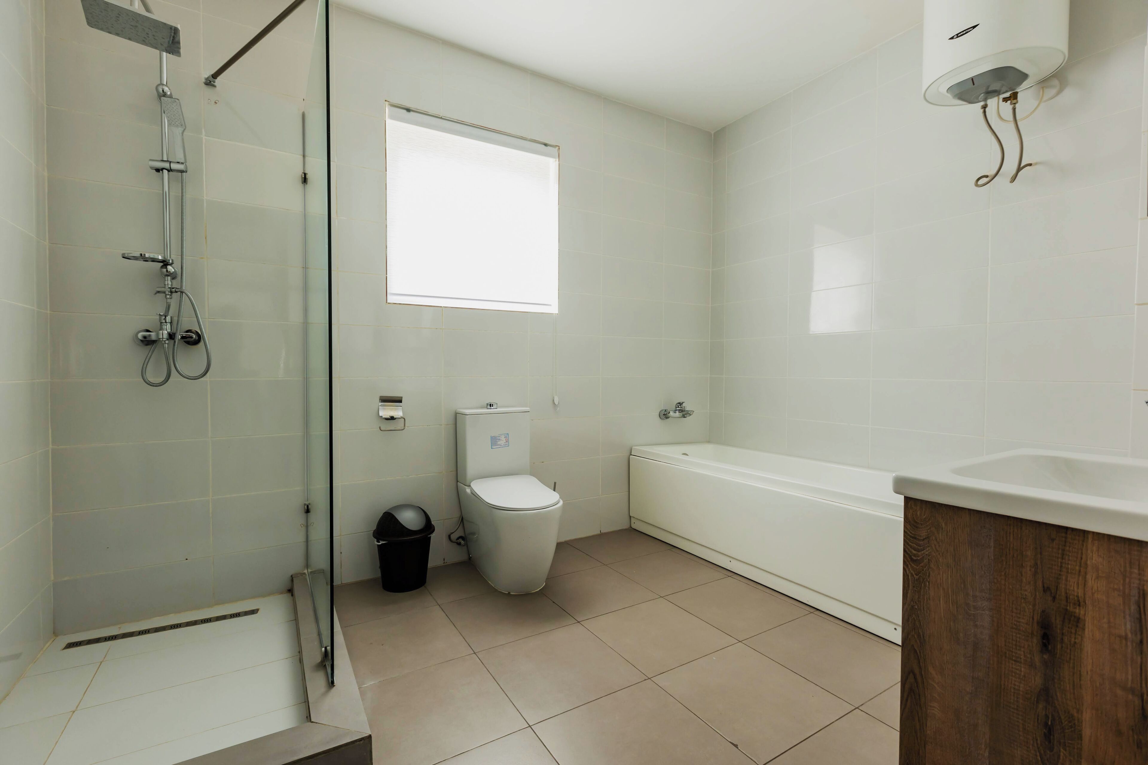 A bathroom with a shower, toilet, and bathtub.