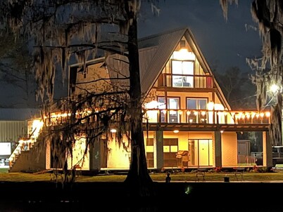 3 levels, 3 bed room spacious waterfront home is located in the Maurepas Swamp