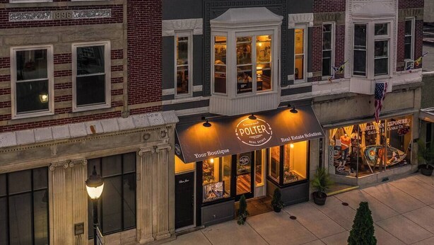 A building with a boutique store named "Polter" on the ground floor, featuring a storefront with a sign and a display window. - “Blame Jaime” downtown, the heart of all the fun! (Port Clinton)