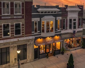 A building with a boutique store named "Polter" on the ground floor, featuring a storefront with a sign and a display window. - “Blame Jaime” downtown, the heart of all the fun! (Port Clinton)