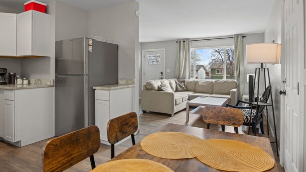 A compact living space with a kitchenette, a dining area with a wooden table and chairs, a sofa, and a view through a window. - Family-Friendly w/ Hot Tub | 12 min to Broadmoor (Colorado Springs)