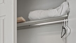 A white door, a metal rack with a white towel, and a metal chair in a room with a light gray wall. - Family-Friendly w/ Hot Tub | 12 min to Broadmoor (Colorado Springs)
