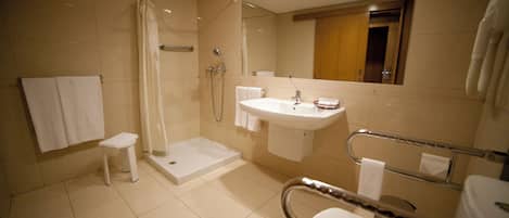 A modern bathroom with a walk-in shower, a sink, and a toilet.