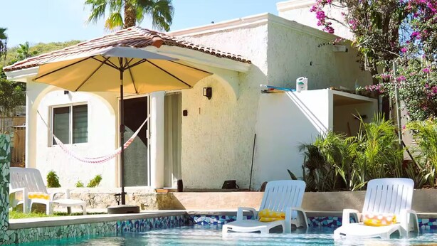 A pool area with lounge chairs and a covered seating area. - Casitas with pool & jacuzzi (Todos Santos)